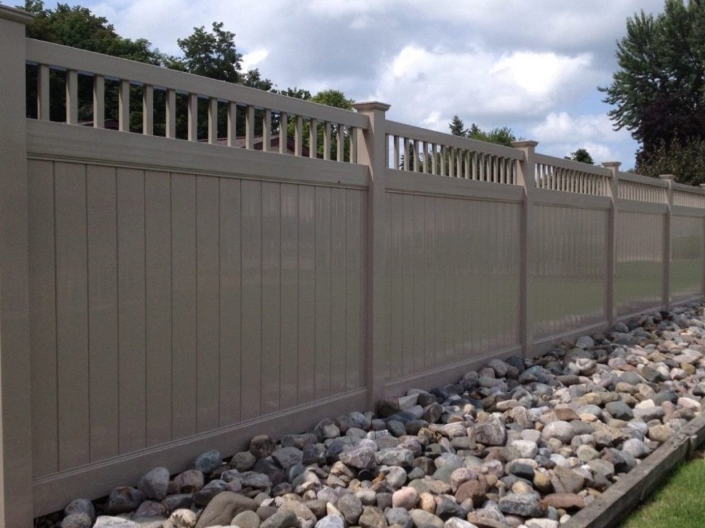 Large vinyl fence with rocks